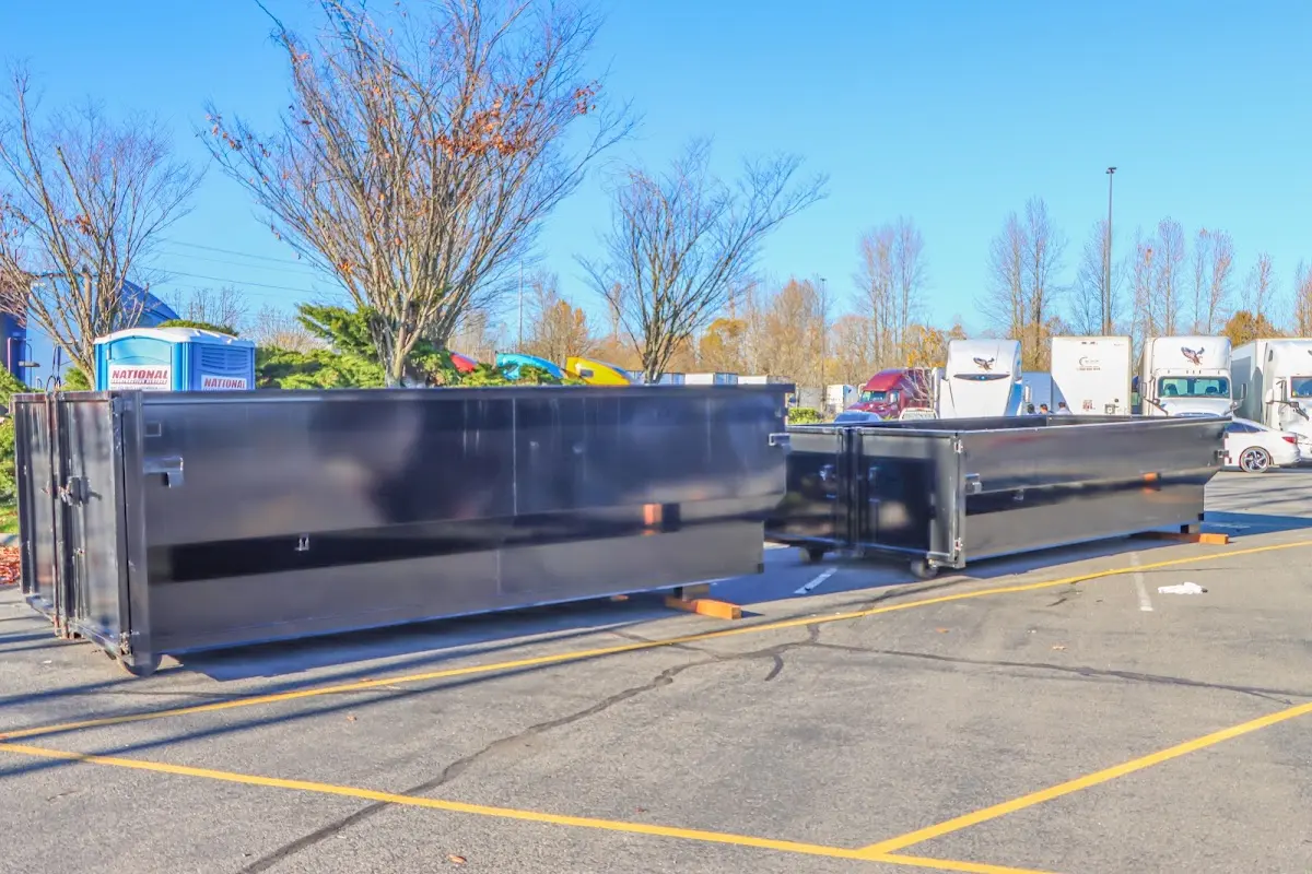 Professional dumpster rental service with roll-off container on residential driveway in Sumpter